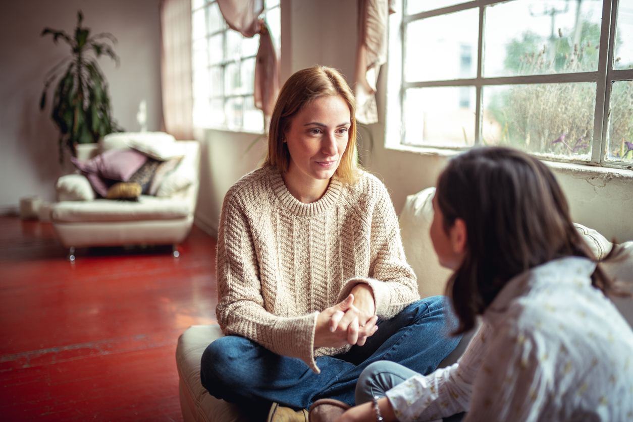 Mother and daughter at home having a talk at home